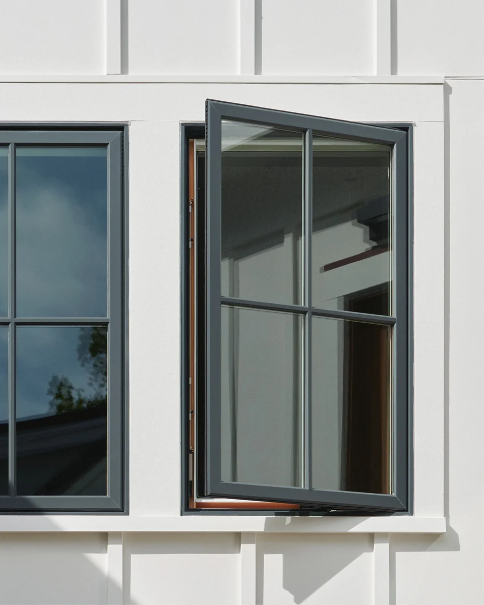 Open black Marvin Elevate casement window on a white home