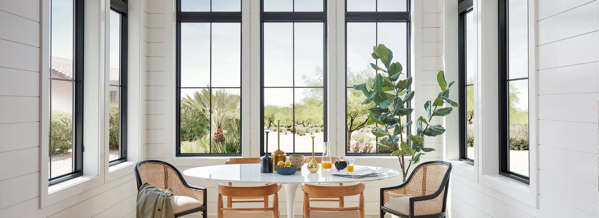 Bright breakfast nook with a wide grouping of Pella Impervia fiberglass windows