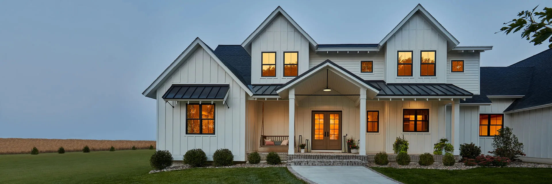 Two-story home with white Pella Impervia fiberglass windows and a tan exterior